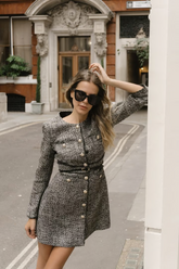 a lady wears a grey tweed mini dress with a round neck design
